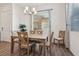 Bright dining room featuring wood floors, modern chandelier, and large windows at 209 Bellini Peak Ave, Henderson, NV 89011
