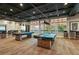 Bright game room features pool tables, natural light and comfortable seating areas at 209 Bellini Peak Ave, Henderson, NV 89011
