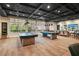 Spacious game room with pool tables, comfortable seating, and ample natural light at 209 Bellini Peak Ave, Henderson, NV 89011