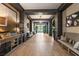 Elegant hallway with stylish decor, wood-look floors, designer lighting and comfortable seating at 209 Bellini Peak Ave, Henderson, NV 89011