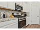 Modern kitchen with stainless steel appliances and granite countertops at 209 Bellini Peak Ave, Henderson, NV 89011