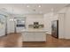 Open-concept kitchen features an island with granite countertops, and stainless steel appliances at 209 Bellini Peak Ave, Henderson, NV 89011