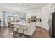Spacious kitchen with granite countertops, white cabinets, and stainless steel appliances at 209 Bellini Peak Ave, Henderson, NV 89011