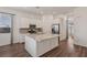 Modern kitchen with a granite island, stainless steel appliances, and ample cabinet space at 209 Bellini Peak Ave, Henderson, NV 89011