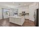 Beautiful kitchen featuring a large granite island, stainless steel appliances, and open layout for entertaining at 209 Bellini Peak Ave, Henderson, NV 89011