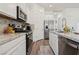 Updated kitchen featuring stainless steel appliances, granite counters, and white cabinetry at 209 Bellini Peak Ave, Henderson, NV 89011