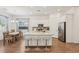 Bright kitchen features a large island with a granite countertop, modern appliances, and a dining area at 209 Bellini Peak Ave, Henderson, NV 89011