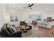 Open-concept living area with modern furniture, hardwood floors, and a seamless flow to the kitchen at 209 Bellini Peak Ave, Henderson, NV 89011