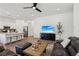 Bright open-concept living area with sleek furniture, hardwood floors, and a seamless flow to the kitchen at 209 Bellini Peak Ave, Henderson, NV 89011