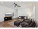 Cozy living room features modern ceiling fan, plush seating, and a sleek entertainment center at 209 Bellini Peak Ave, Henderson, NV 89011