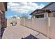 Outdoor patio with a stainless steel grill, brick pillars, and a white fence at 209 Bellini Peak Ave, Henderson, NV 89011