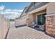 Outdoor patio with brick flooring, exterior furniture, and a white fence at 209 Bellini Peak Ave, Henderson, NV 89011