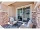 Cozy patio space featuring brick pillars, brick flooring, and two outdoor chairs at 209 Bellini Peak Ave, Henderson, NV 89011