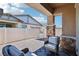 Covered outdoor patio space with brick flooring, brick pillars, and exterior furniture at 209 Bellini Peak Ave, Henderson, NV 89011