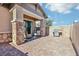 Covered outdoor patio space with brick flooring, brick pillars, and a stainless steel grill at 209 Bellini Peak Ave, Henderson, NV 89011