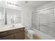 Well-lit bathroom features a shower-tub combo, brown vanity with a white countertop, and white tile floors at 231 W Horizon Ridge Pkwy # 212, Henderson, NV 89012