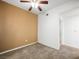 Comfortable bedroom with neutral carpet, ceiling fan and a tan accent wall at 231 W Horizon Ridge Pkwy # 212, Henderson, NV 89012