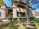 A two-story building featuring balconies, green shrubs, and trees, offering a serene outdoor environment at 231 W Horizon Ridge Pkwy # 212, Henderson, NV 89012