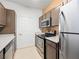 Well-lit kitchen featuring stainless steel appliances and ample cabinet space at 231 W Horizon Ridge Pkwy # 212, Henderson, NV 89012