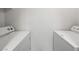 Clean laundry area featuring a white washing machine and a white dryer against a white wall at 231 W Horizon Ridge Pkwy # 212, Henderson, NV 89012