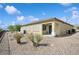 The backyard is low maintenance with desert landscaping, covered patio, and privacy shades at 2453 Vivid Sky Pl, Henderson, NV 89044