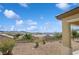 Landscaped backyard featuring desert plants, a rock ground cover, and mountain views at 2453 Vivid Sky Pl, Henderson, NV 89044