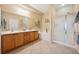 Bathroom with double vanity, soaking tub and glass enclosed shower at 2453 Vivid Sky Pl, Henderson, NV 89044