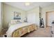 Cozy bedroom with a ceiling fan, natural light, and a tropical-themed quilt at 2453 Vivid Sky Pl, Henderson, NV 89044
