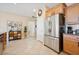 Bright kitchen with stainless steel refrigerator and view of the hallway and cabinetry at 2453 Vivid Sky Pl, Henderson, NV 89044