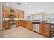 Well-equipped kitchen featuring stainless steel appliances, wooden cabinets, and a spacious island at 2453 Vivid Sky Pl, Henderson, NV 89044