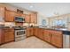 Spacious kitchen with wood cabinets, granite countertops, and a stainless steel range at 2453 Vivid Sky Pl, Henderson, NV 89044