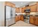 Well-lit kitchen featuring stainless steel appliances and wood cabinets at 2453 Vivid Sky Pl, Henderson, NV 89044