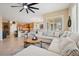 Spacious living room with a large sectional and ample natural light at 2453 Vivid Sky Pl, Henderson, NV 89044