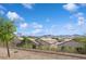 Neighborhood homes beyond a fenced back yard with a backdrop of mountains at 2453 Vivid Sky Pl, Henderson, NV 89044