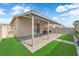 Inviting backyard with covered patio, brick pavers, green grass, and secure fencing for outdoor enjoyment at 2633 Spider Cactus Ct, Las Vegas, NV 89106
