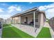 Charming backyard with covered patio, lush green grass, and a tranquil atmosphere, perfect for entertaining at 2633 Spider Cactus Ct, Las Vegas, NV 89106