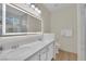 Bathroom with double sinks, an illuminated mirror, and marble countertops at 2633 Spider Cactus Ct, Las Vegas, NV 89106