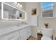 Bright bathroom with an illuminated mirror and stylish vanity at 2633 Spider Cactus Ct, Las Vegas, NV 89106