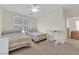 Bedroom with neutral walls features two beds and ceiling fan at 2633 Spider Cactus Ct, Las Vegas, NV 89106