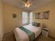 Comfortable bedroom featuring a queen-sized bed, ceiling fan, and a serene atmosphere at 2633 Spider Cactus Ct, Las Vegas, NV 89106