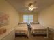 Cozy bedroom with two twin beds, ceiling fan, and plenty of natural light at 2633 Spider Cactus Ct, Las Vegas, NV 89106