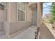 Close-up of the front entrance, showcasing a secure metal gate door and decorative outdoor lighting at 2633 Spider Cactus Ct, Las Vegas, NV 89106