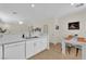 Open-concept kitchen features white cabinets and countertops, and stainless steel dishwasher at 2633 Spider Cactus Ct, Las Vegas, NV 89106