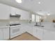 Bright kitchen features white cabinets, marble countertops, and stainless steel appliances at 2633 Spider Cactus Ct, Las Vegas, NV 89106