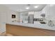 Well-lit kitchen featuring white cabinetry, stainless steel appliances, and a breakfast bar at 2633 Spider Cactus Ct, Las Vegas, NV 89106
