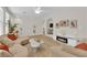 Inviting living room with stylish furniture, a cozy fireplace, and seamless flow to other living spaces at 2633 Spider Cactus Ct, Las Vegas, NV 89106