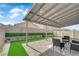 Cozy covered patio with brick pavers, comfortable seating, and a well-manicured lawn for relaxation at 2633 Spider Cactus Ct, Las Vegas, NV 89106