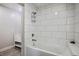 Bathroom featuring white subway tile surround, a built-in tub, and vanity in the adjacent room at 280 Gentry St, Overton, NV 89040
