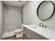 Bathroom features a vanity with marble countertop, modern fixtures, and tile in the shower at 280 Gentry St, Overton, NV 89040