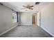 Bedroom with soft carpet flooring, a ceiling fan, and a large window at 280 Gentry St, Overton, NV 89040